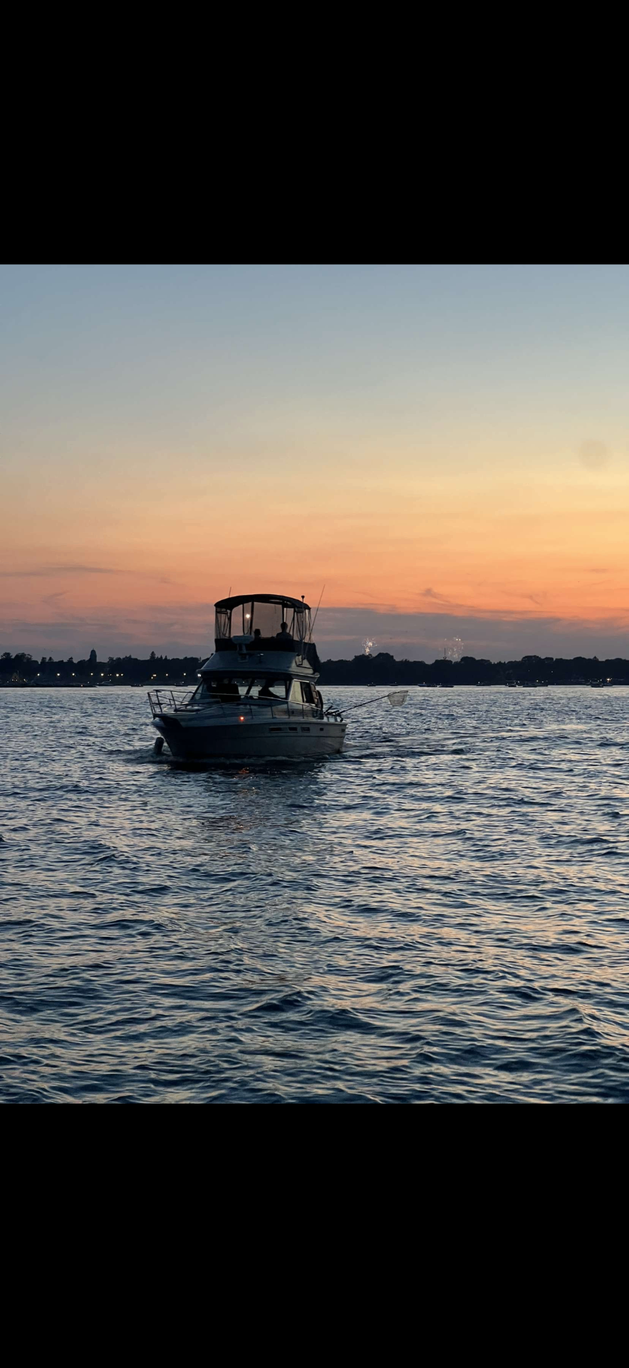 Yacht cruising at sunset on Lake Michigan